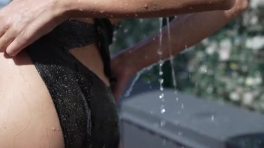 This stock slow motion video shows a sexy woman taking a shower