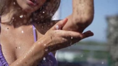This stock slow motion video shows a sexy woman taking a shower