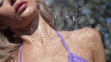 This stock slow motion video shows a sexy woman taking a shower