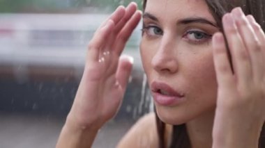 This stock slow motion video shows a sexy woman taking a shower