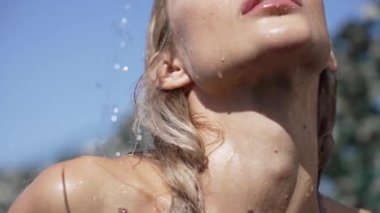 This stock slow motion video shows a sexy woman taking a shower