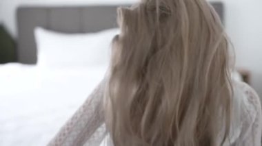 This stock video shows a beautiful woman in sexy lingerie, slow motion