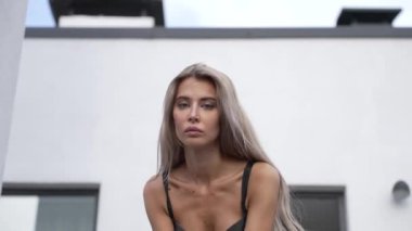 This stock video shows a beautiful woman in sexy lingerie, slow motion