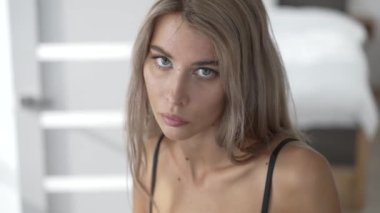 This stock video shows a beautiful woman in sexy lingerie, slow motion