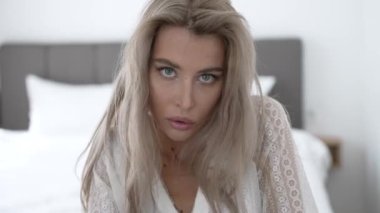 This stock video shows a beautiful woman in sexy lingerie, slow motion