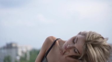 This stock video shows a beautiful woman in sexy lingerie, slow motion