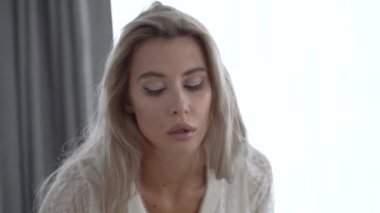 This stock video shows a beautiful woman in sexy lingerie, slow motion