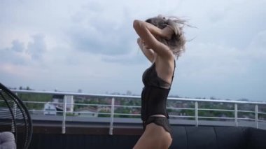 This stock video shows a beautiful woman in sexy lingerie, slow motion