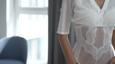 This stock video shows a beautiful woman in sexy lingerie, slow motion