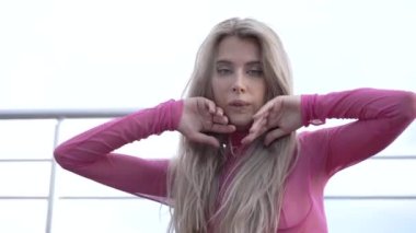 This stock video shows a beautiful woman in sexy lingerie, slow motion