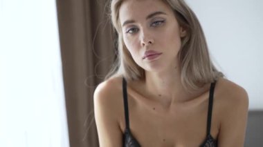 This stock video shows a beautiful woman in sexy lingerie, slow motion
