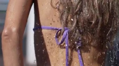 This stock slow motion video shows a sexy woman taking a shower