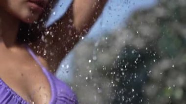 This stock slow motion video shows a sexy woman taking a shower