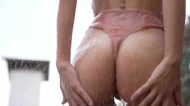 This stock slow motion video shows a sexy woman taking a shower
