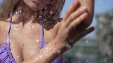 This stock slow motion video shows a sexy woman taking a shower