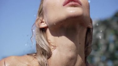 This stock slow motion video shows a sexy woman taking a shower