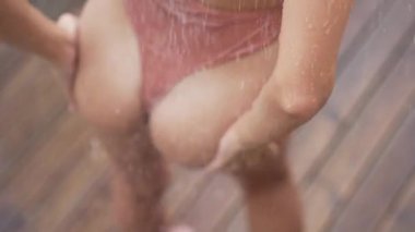 This stock slow motion video shows a sexy woman taking a shower