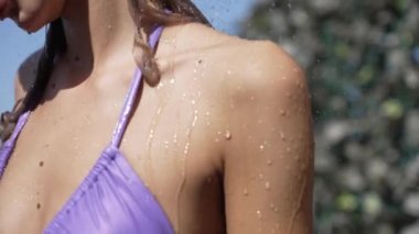 This stock slow motion video shows a sexy woman taking a shower