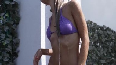 This stock slow motion video shows a sexy woman taking a shower