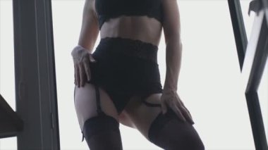 This stock video shows a beautiful woman in sexy lingerie, slow motion in 8K resolution