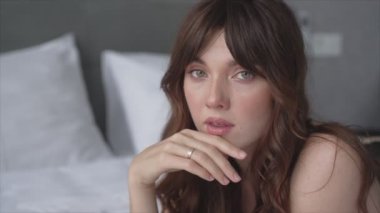 This stock video shows a beautiful woman in sexy lingerie, slow motion in 8K resolution