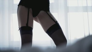 This stock video shows a beautiful woman in sexy lingerie, slow motion in 8K resolution