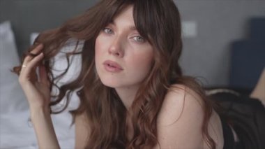 This stock video shows a beautiful woman in sexy lingerie, slow motion in 8K resolution