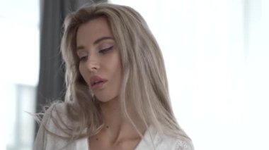 This stock video shows a beautiful woman in sexy lingerie, slow motion