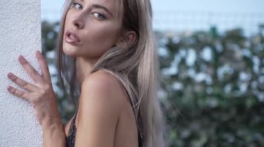This stock video shows a beautiful woman in sexy lingerie, slow motion