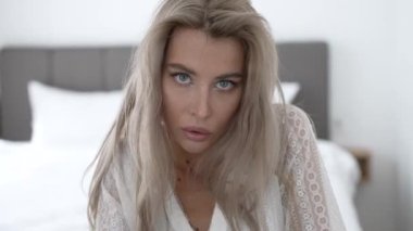 This stock video shows a beautiful woman in sexy lingerie, slow motion