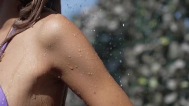 This stock slow motion video shows a sexy woman taking a shower