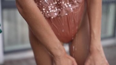 This stock slow motion video shows a sexy woman taking a shower