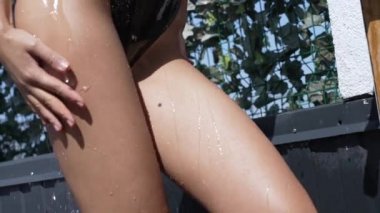 This stock slow motion video shows a sexy woman taking a shower