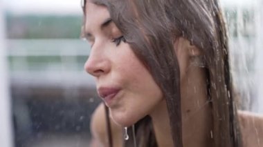 This stock slow motion video shows a sexy woman taking a shower