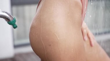 This stock slow motion video shows a sexy woman taking a shower