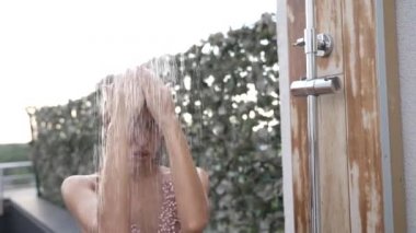 This stock slow motion video shows a sexy woman taking a shower