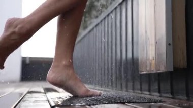 This stock slow motion video shows a sexy woman taking a shower
