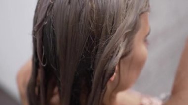 This stock slow motion video shows a sexy woman taking a shower