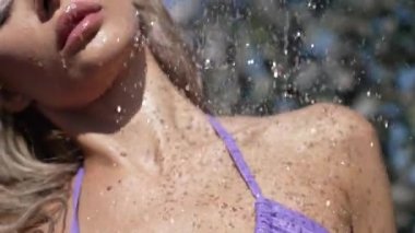 This stock slow motion video shows a sexy woman taking a shower