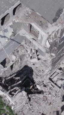 Bu stok dikey video, Borodyanka, Bucha bölgesinde gri, renksiz, düz bir bina gösteriyor.