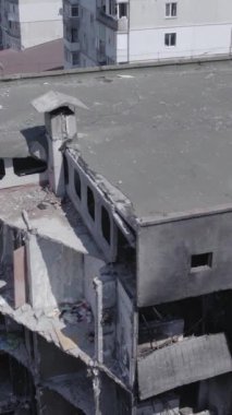 Bu stok dikey video, Borodyanka, Bucha bölgesinde gri, renksiz, düz bir bina gösteriyor.