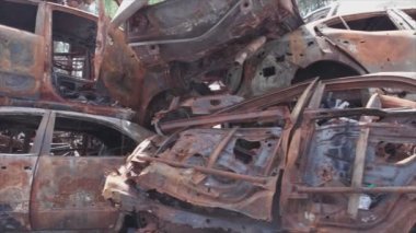 This stock video shows a dump of shot and burned cars in Irpin, Bucha district in 8K resolution