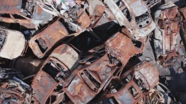 This stock video shows a dump of shot and burned cars in Irpin, Bucha district in 8K resolution