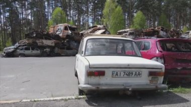 This stock video shows a dump of shot and burned cars in Irpin, Bucha district in 8K resolution