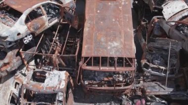 This stock video shows a dump of shot and burned cars in Irpin, Bucha district in 8K resolution