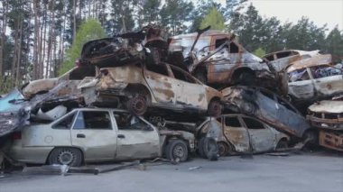 This stock video shows a dump of shot and burned cars in Irpin, Bucha district in 8K resolution
