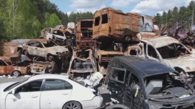 This stock video shows a dump of shot and burned cars in Irpin, Bucha district in 8K resolution