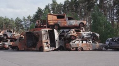 This stock video shows a dump of shot and burned cars in Irpin, Bucha district in 8K resolution