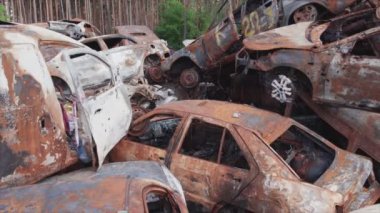 This stock video shows a dump of shot and burned cars in Irpin, Bucha district in 8K resolution