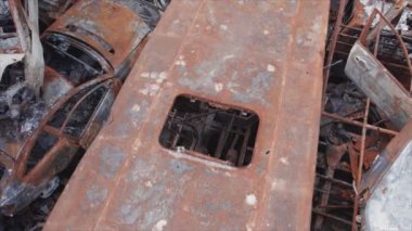 This stock video shows a dump of shot and burned cars in Irpin, Bucha district in 8K resolution